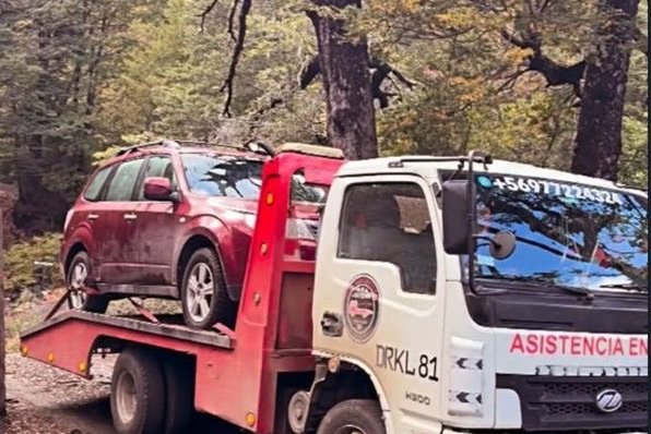Grúa plana de Grúa San Cristóbal trasladando un vehículo en la ruta hacia Santiago